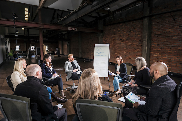 Executive team taking part in a facilitated group discussion