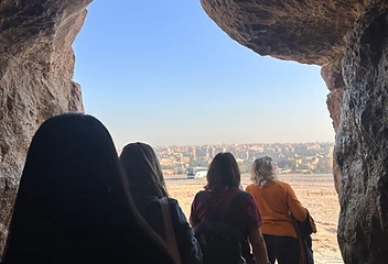 View from inside a stone-hewn passage looking out to the desert