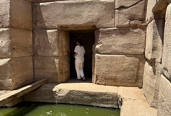 Ancient stone chamber with a still pool of green water