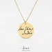 close up macro detail of authentic handwritten signature engraving on gold disc pendant
