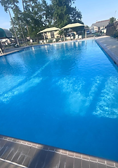Pool deck and bright blue water in daylight