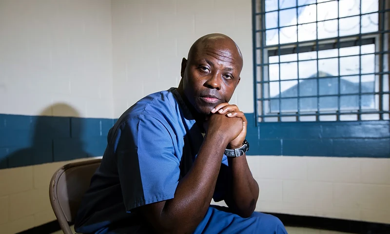 Thomas R. James seated in a prison room