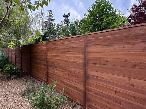 Horizontal wood privacy fence along a sloped lot