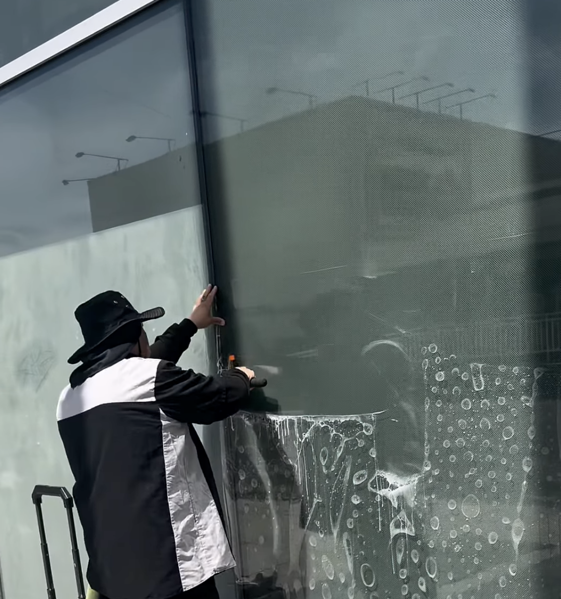 Anti-graffiti film installation on storefront glass
