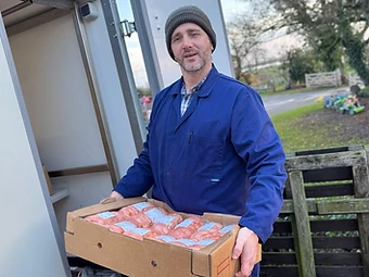 Butcher Tim Verey carrying fresh meat for the hampers