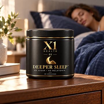 X1 Health Deeper Sleep tub on a wooden nightstand with a person sleeping in a navy-lined bed in the background