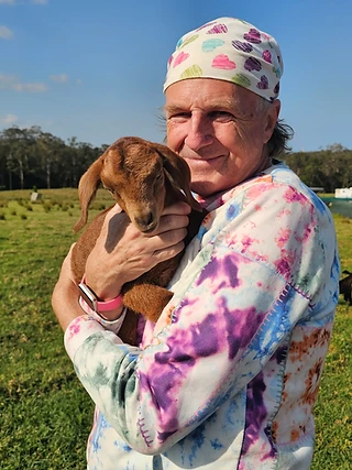 A gentle cuddle with a baby goat at the farm