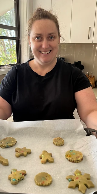 Beaming over a tray of freshly cut biscuits