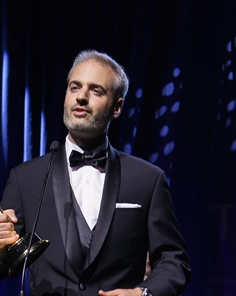 Nathan Pangrazio holding his Emmy Award