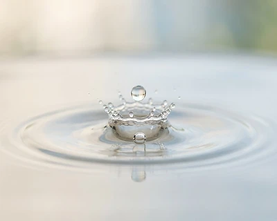 A single drop of water hitting a calm surface
