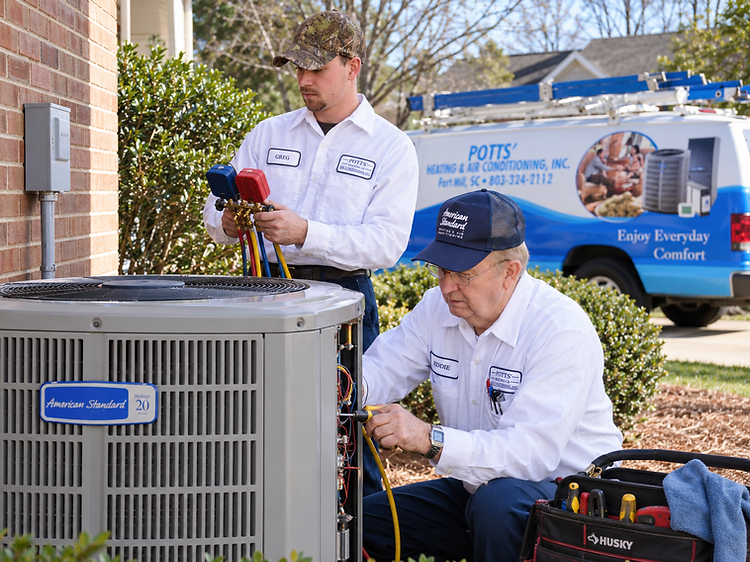 Potts' technicians servicing an American Standard air conditioner in Fort Mill, SC