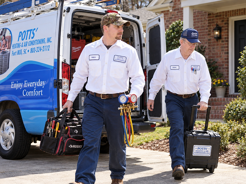 Potts' Heating & Air Conditioning technicians arriving with a service van in Fort Mill, SC