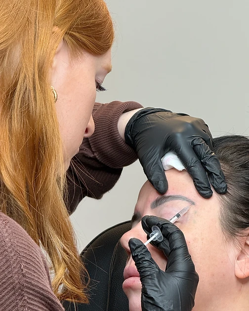 Practitioner administering an injectable treatment