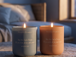 A warm flame glowing softly through engraved words on a frosted blue candle