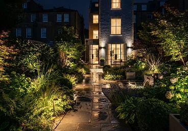 Stone garden path lit with low-level LED path lights in London