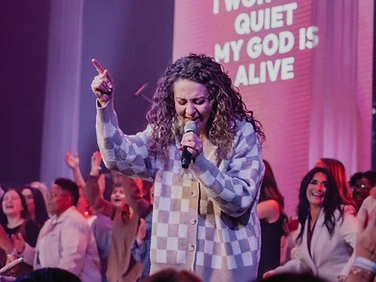 Vocalist worshipping on the Devoted stage