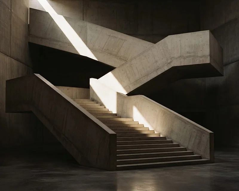 Sunlight and shadow across a sculptural concrete staircase