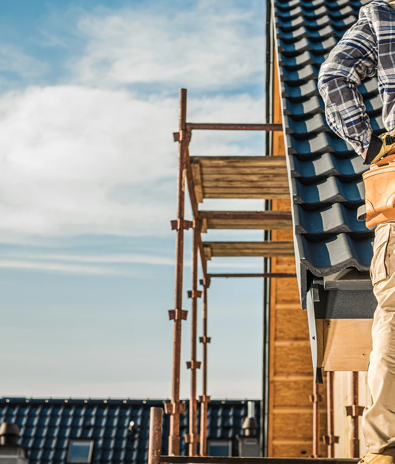 Roofer at work on a tiled roof