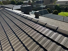 Completed dark tiled roof restoration close-up