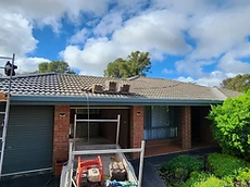 Professional roof cleaning and maintenance in progress