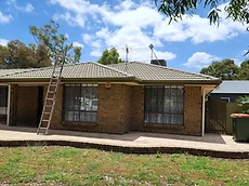 Tiled roof restoration project with ladder access