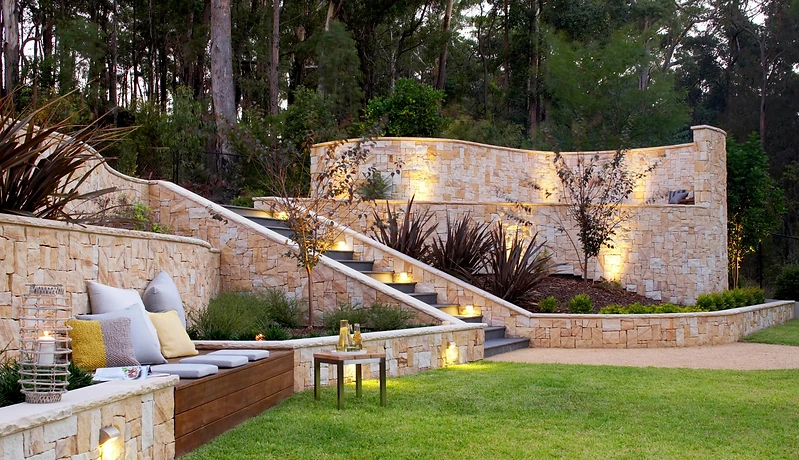 Finished residential stonework with illuminated retaining walls