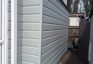 New grey cladding with white fascia, soffit and downpipe