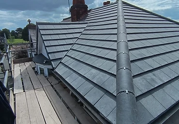 New grey slate roofs viewed from scaffold