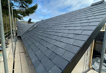 New slate roof being laid on scaffolding