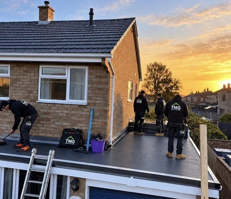 TMG roofing team working on a property at sunset