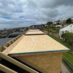 Dormer frame and boarded roof under construction, ready for tiles and lead