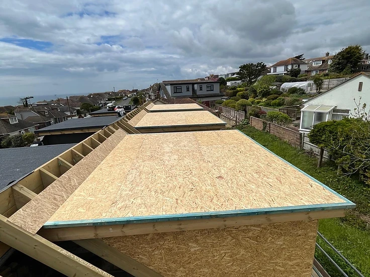 Dormer frame and boarded roof under construction, ready for tiles and lead