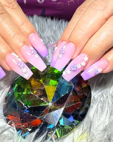 Coffin nails with purple ombre French tips and 3D white and lavender flowers