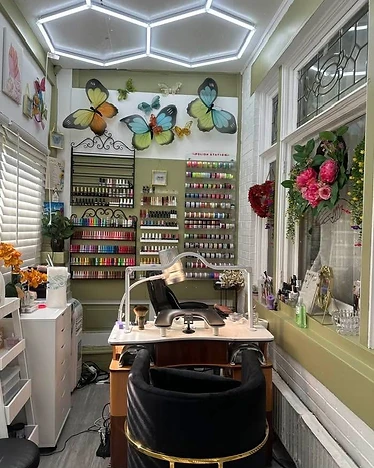 The salon area — Mary's manicure station with butterfly wall decor and polish racks