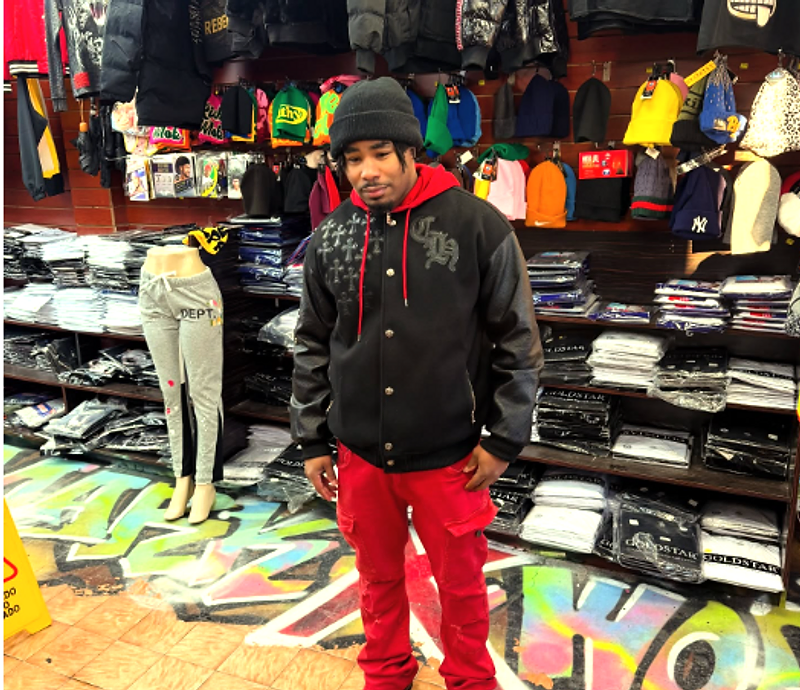 Customer in a varsity jacket at MARK X WORLD