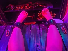 Ankle cuffs on the wooden frame in magenta