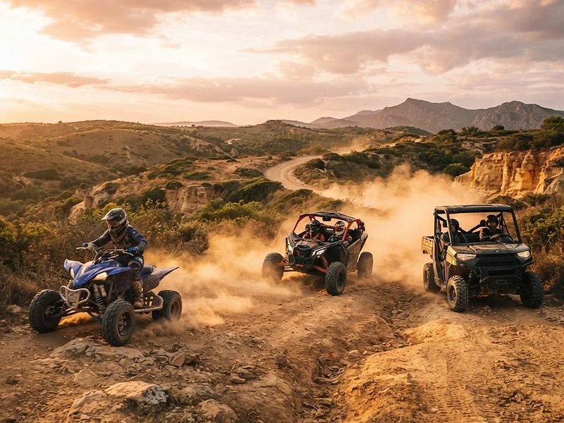Off-road vehicles kicking up dust on an Algarve trail at golden hour