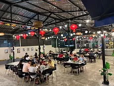 Open-air dining space with globe string lights