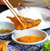 A piece of fried fish served with dipping sauces at Asia Thai Restaurant