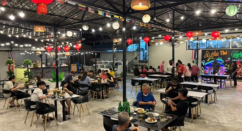 Open-air dining area at Asia Thai Restaurant under lanterns