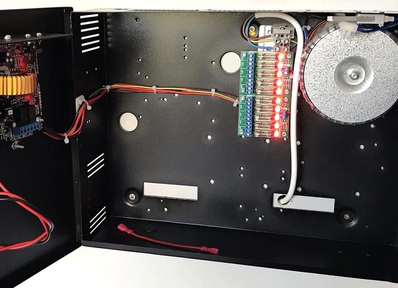 Inside a Power-Plex unit: toroidal transformer and fused output board under test