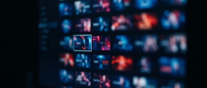 Close-up of a television screen showing a grid of programme tiles