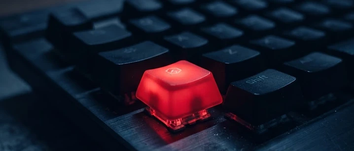 Keyboard with a single red illuminated key in dark surroundings, illustrating M3U playlist errors in IPTV players