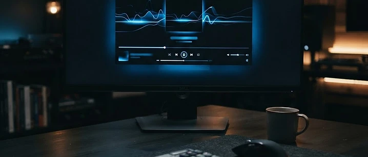 Desktop monitor showing a dark media player interface on a desk, illustrating IPTV playback on a Windows PC in the UK