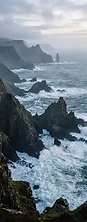 Aerial view of a rugged Scottish coastline at dawn