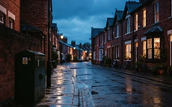 Red brick British terraced street at dusk with a broadband street cabinet, illustrating ISP blocking of IPTV in the UK