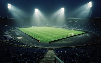 Floodlit football stadium at night seen from the stands, illustrating IPTV football streaming quality checks for UK viewers