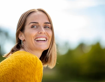 Woman smiling in warm sunlight