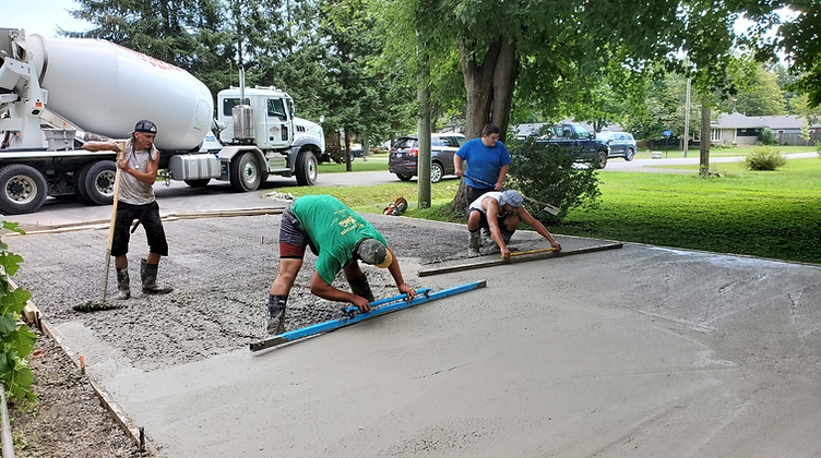 Nexxt Level Concrete crew finishing a driveway pour in Niagara