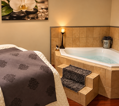 A massage table beside a candlelit tiled soaking tub